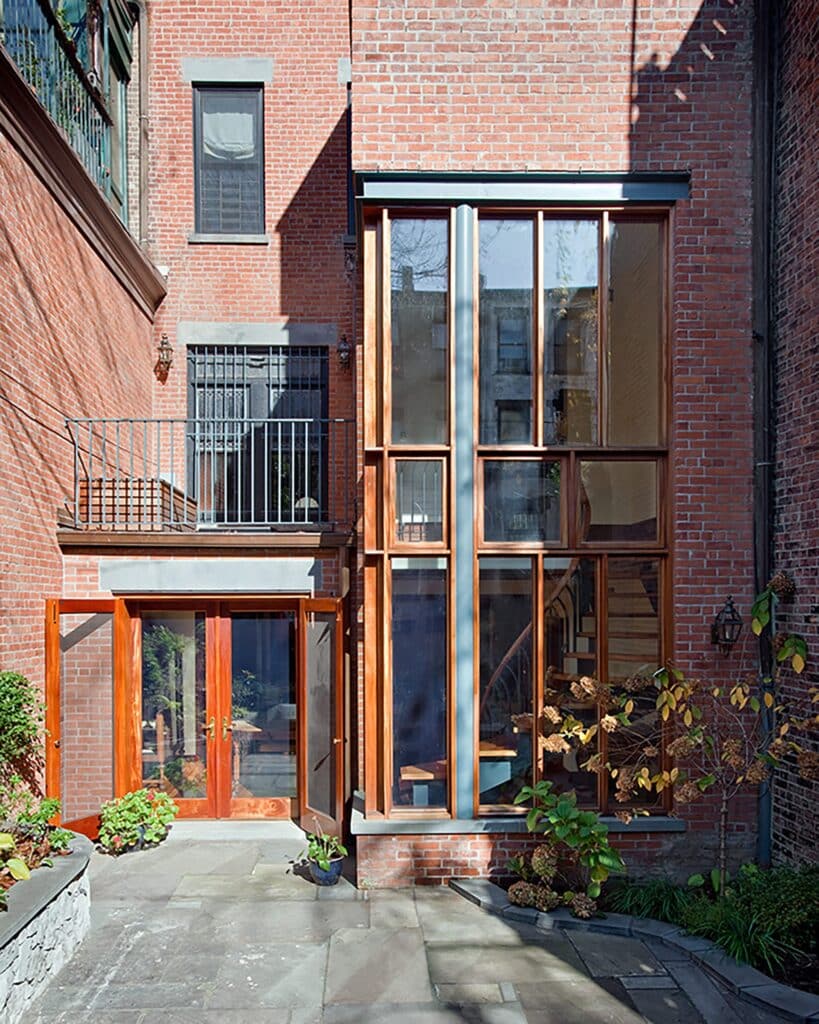 The backyard of the Park Slope house showing two levels, the garden, and natural light flow