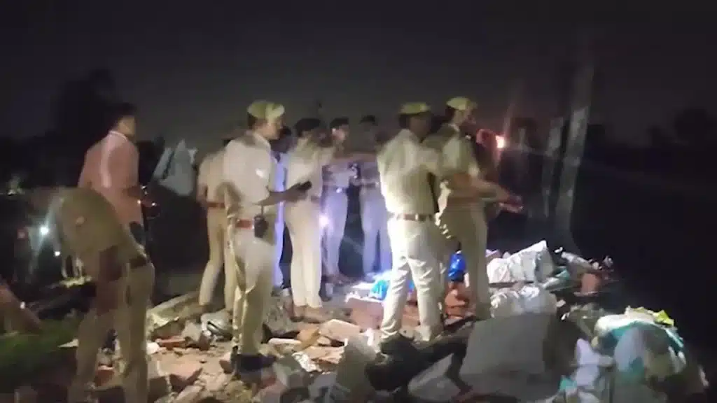 Rescue teams search through debris after a gas cylinder blast caused a house collapse in Ayodhya.