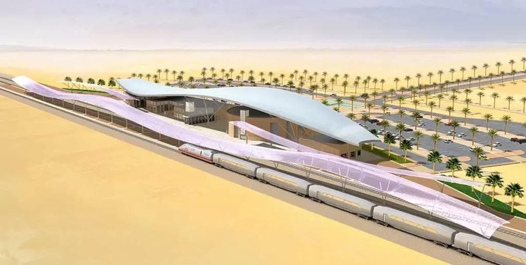 An artistic rendering of a futuristic train station in the Saudi desert, featuring a sleek, curved roof shading platforms, with a high-speed train passing by and palm-lined walkways adding greenery to the arid landscape.