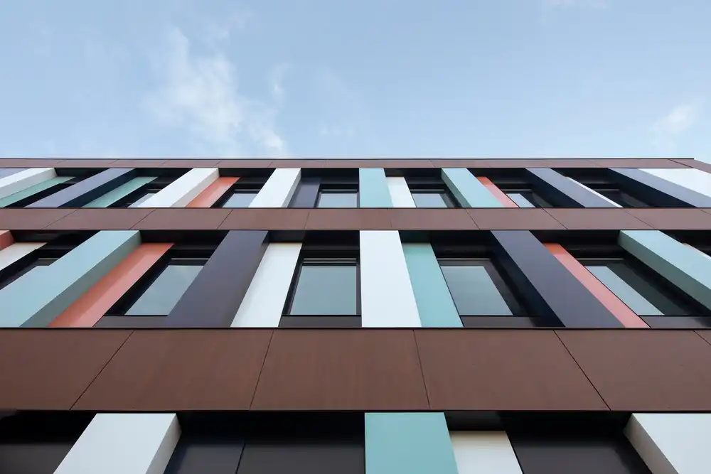 Close-up of CRJDA Sainte-Thérèse’s colorful, rhythmic facade under a clear sky.