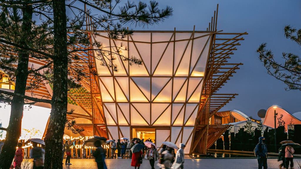 Aerial perspective of Bahrain Pavilion highlighting its layered wooden roof and open-air terraces