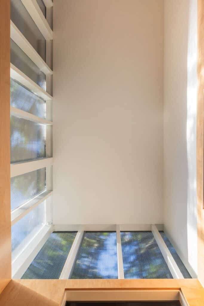 Soft, filtered sunlight streams through the polycarbonate ceiling panels in the new office.