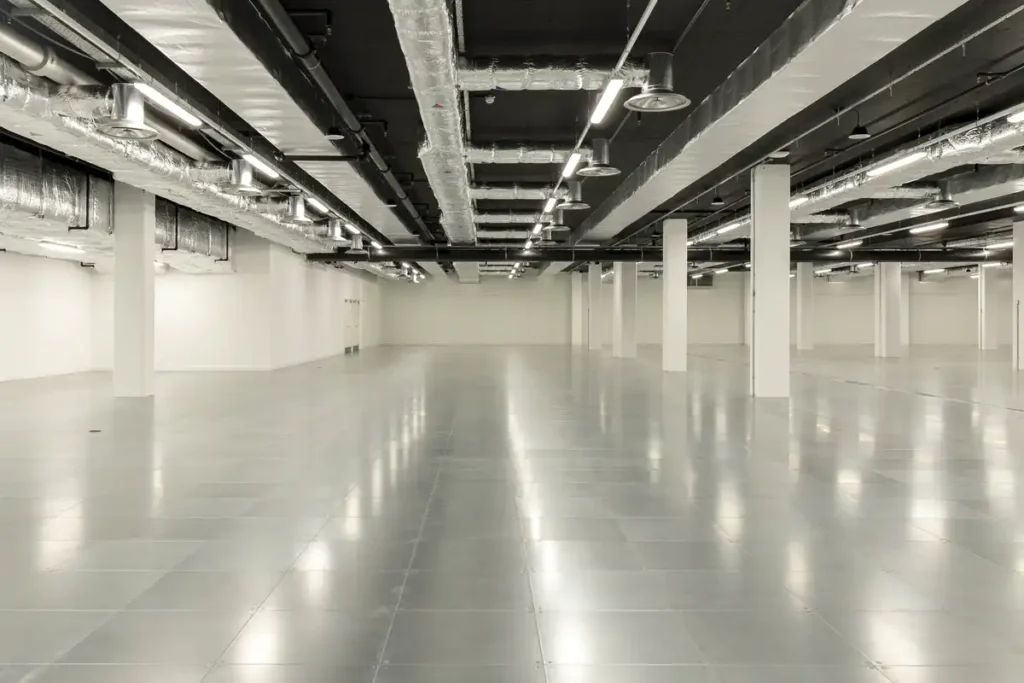 An empty, gleaming hall inside Immerse LDN &mdash; polished floors reflect the industrial ceiling with exposed ducts and beams. It&rsquo;s quiet now&hellip; but you can almost hear the buzz of future exhibitions, concerts, or pop-up markets about to fill this blank canvas.
