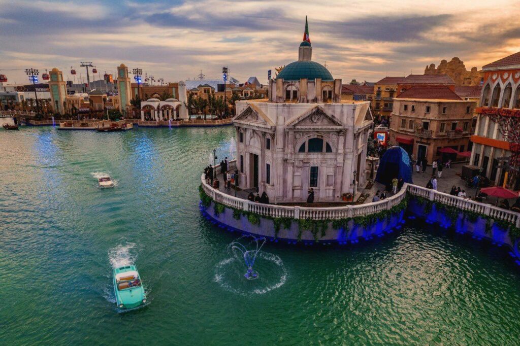 مشهد جوي ساحر لجزء من موسم الرياض 6، يظهر فيه مبنى على شكل كنيسة إيطالية تقليدية مع قبة زرقاء وعلم إيطالي على القمة