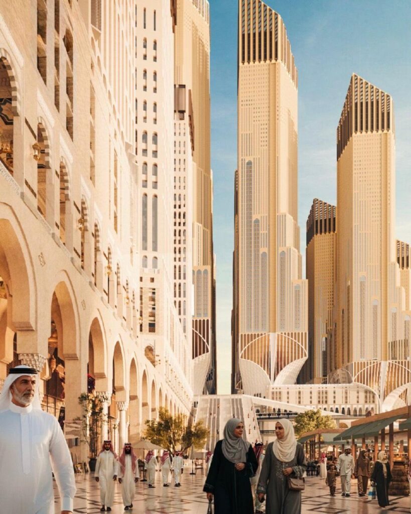 A modern urban scene in Makkah showing people walking between towering skyscrapers designed with contemporary Islamic architecture, reflecting the city&rsquo;s ongoing transformation near the Grand Mosque