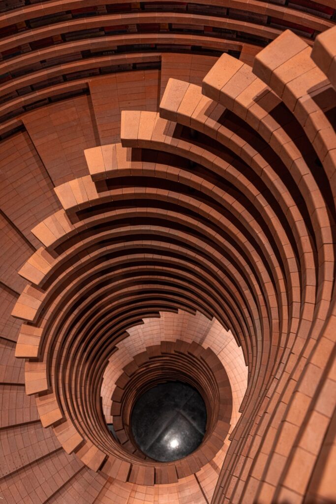 Top-down view of a spiral brick staircase at Zhongshuge &mdash; like diving into a well of knowledge.