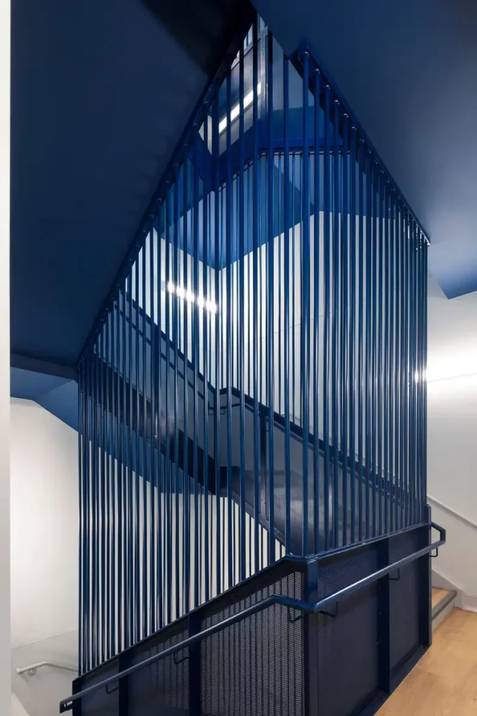 Bold blue staircase at CRJDA Sainte-Thérèse — modern, safe, and full of character