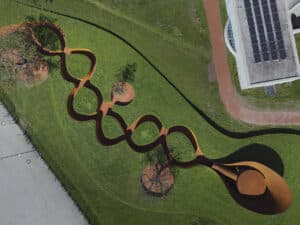 Doshi Retreat at Vitra, a pavilion made of corten steel and minimalist forms seen in the green countryside