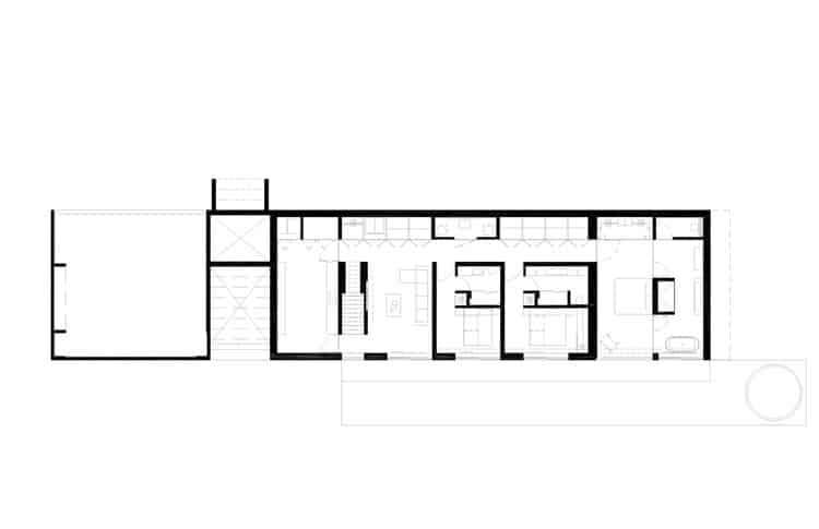 Residential building in Laurentians integrated with surrounding nature and interior spaces.