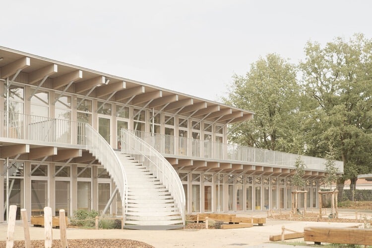 Facade of Jules Verne School complex with main entrance and front courtyard