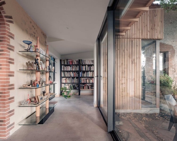 Exterior view of Clos Saint-Martin project blending historical stone buildings with modern wooden extensions and landscaped terraces.