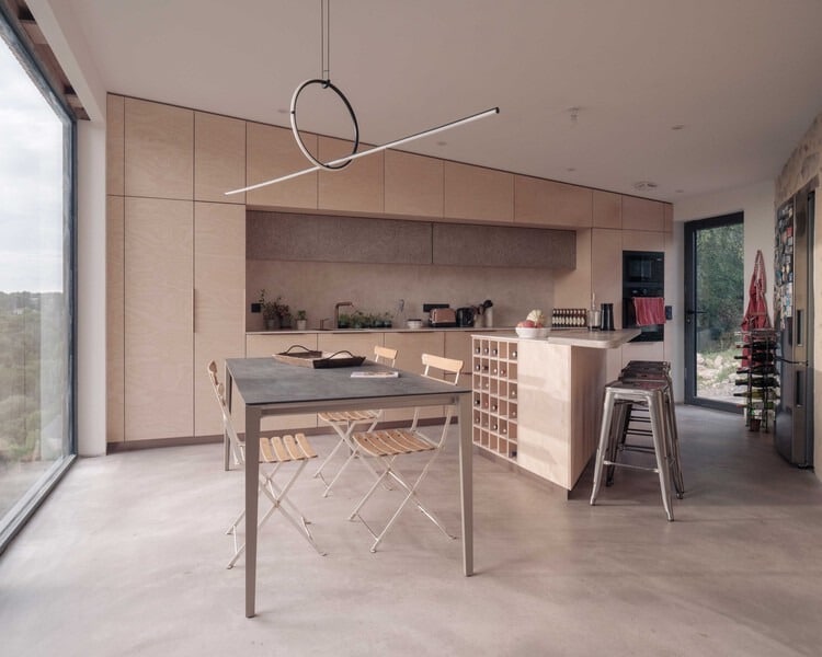 Exterior view of Clos Saint-Martin project blending historical stone buildings with modern wooden extensions and landscaped terraces.