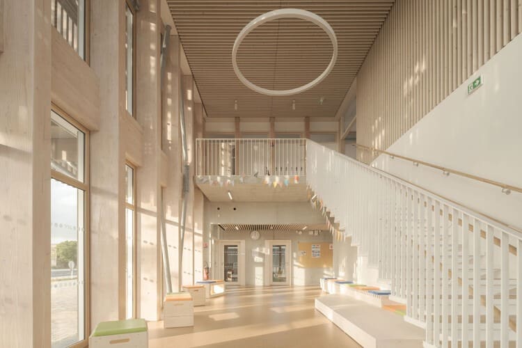 Facade of Jules Verne School complex with main entrance and front courtyard