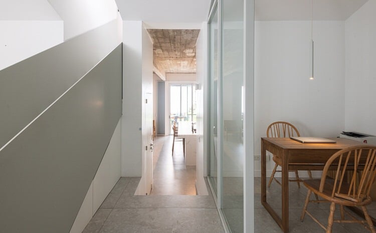 Front fa&ccedil;ade of Po-Yo House with exposed concrete box and metal frames around openings