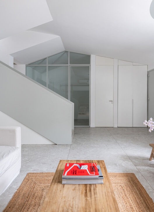 Front fa&ccedil;ade of Po-Yo House with exposed concrete box and metal frames around openings