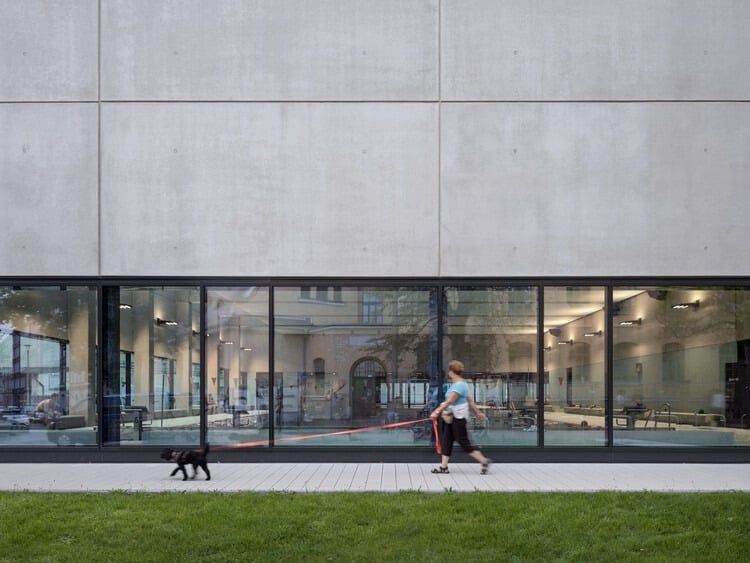 Indoor swimming pool at Sportbad am Rabet project in Leipzig, showing modular design, use of glass and exposed concrete, and open spaces integrated with nature and urban context.