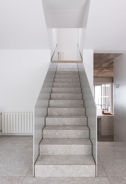 Front fa&ccedil;ade of Po-Yo House with exposed concrete box and metal frames around openings