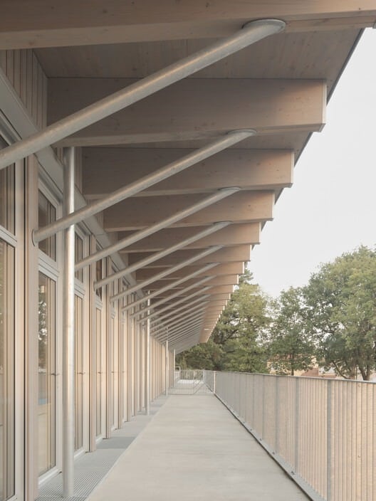 Facade of Jules Verne School complex with main entrance and front courtyard