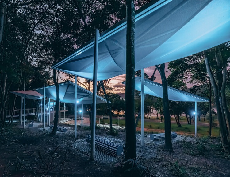 Semi-transparent floating pavilions within the local forest