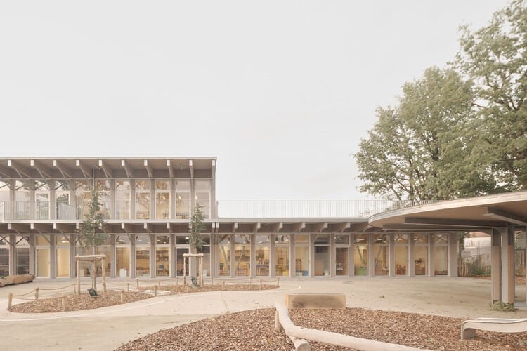 Facade of Jules Verne School complex with main entrance and front courtyard