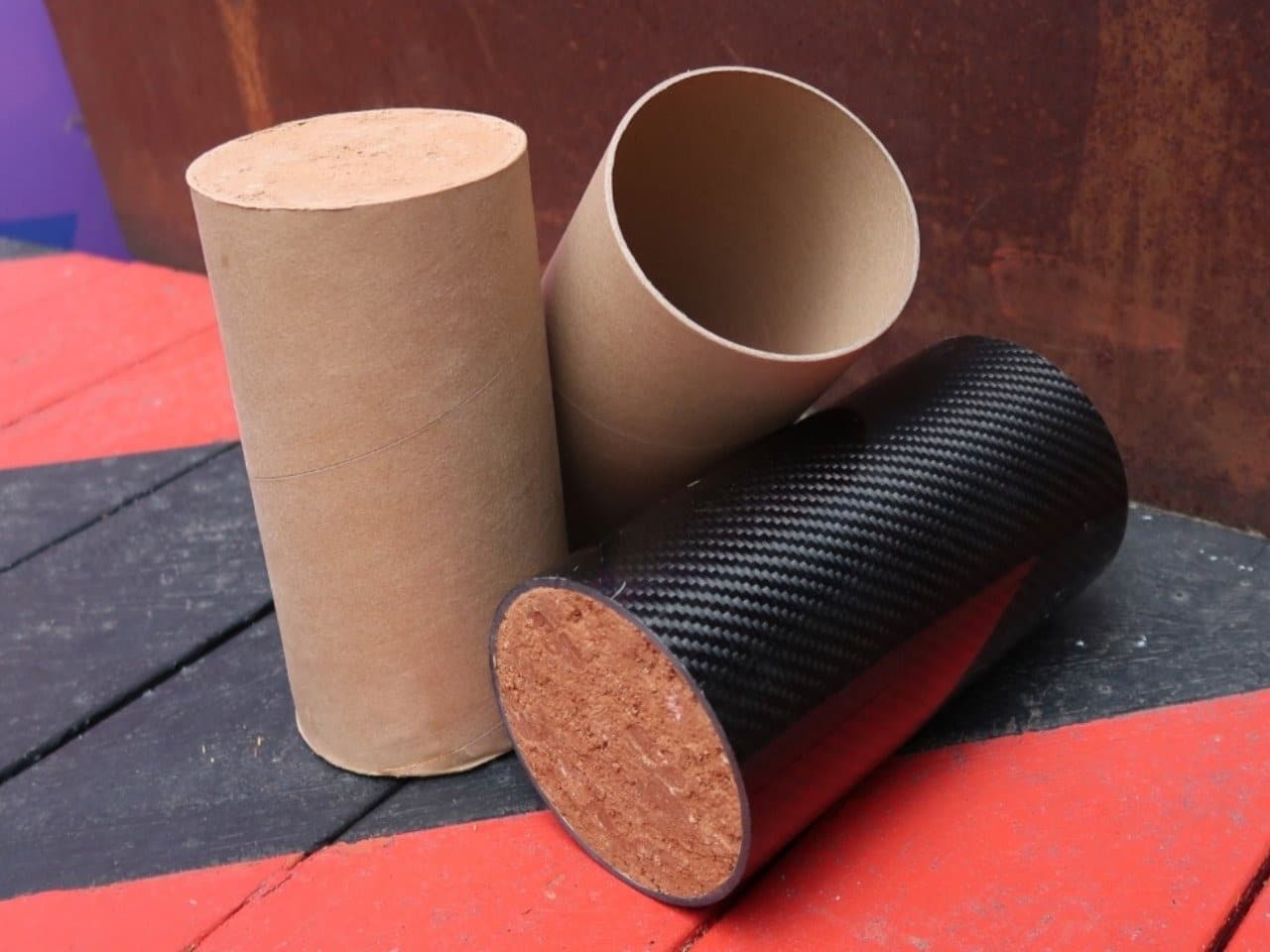 Compressed soil inside cardboard tubes forming sustainable CCRE material