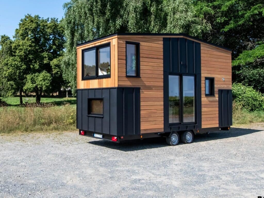 Exterior design of a small house featuring natural wood and black accents
