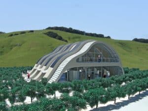 Facade of the Solar Vineyard House with concrete and glass arches reflecting the surrounding hills