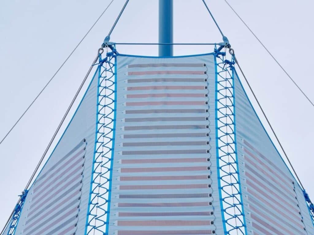 Umbra Pavilion facade with sky-blue roof and Heliotex solar materials