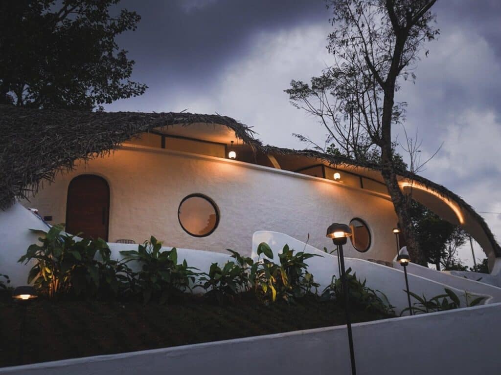 Earth&rsquo;s Embrace building emerging naturally from the green hillside in Wayanad, Kerala