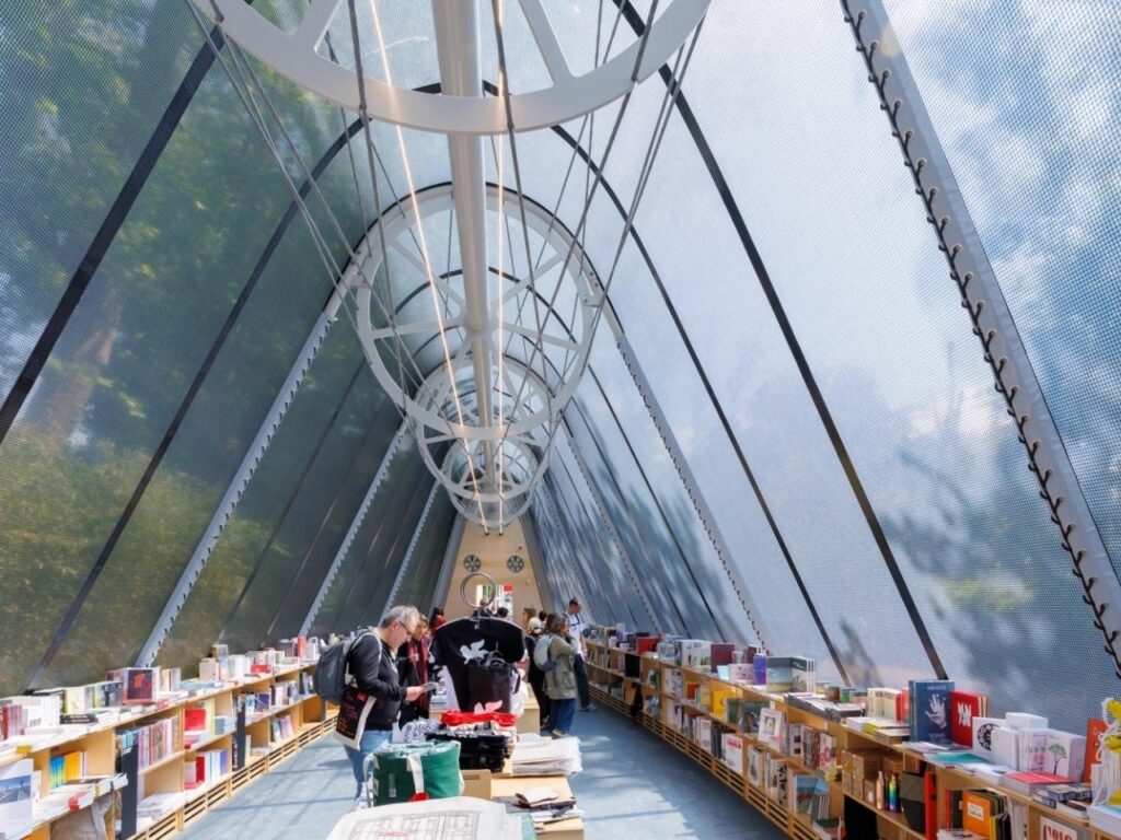 La Libreria mobile library resembling a greenhouse, surrounded by visitors