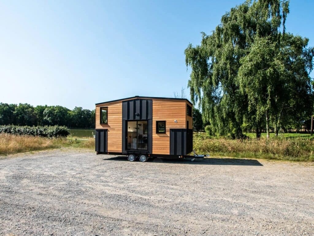 Exterior design of a small house featuring natural wood and black accents