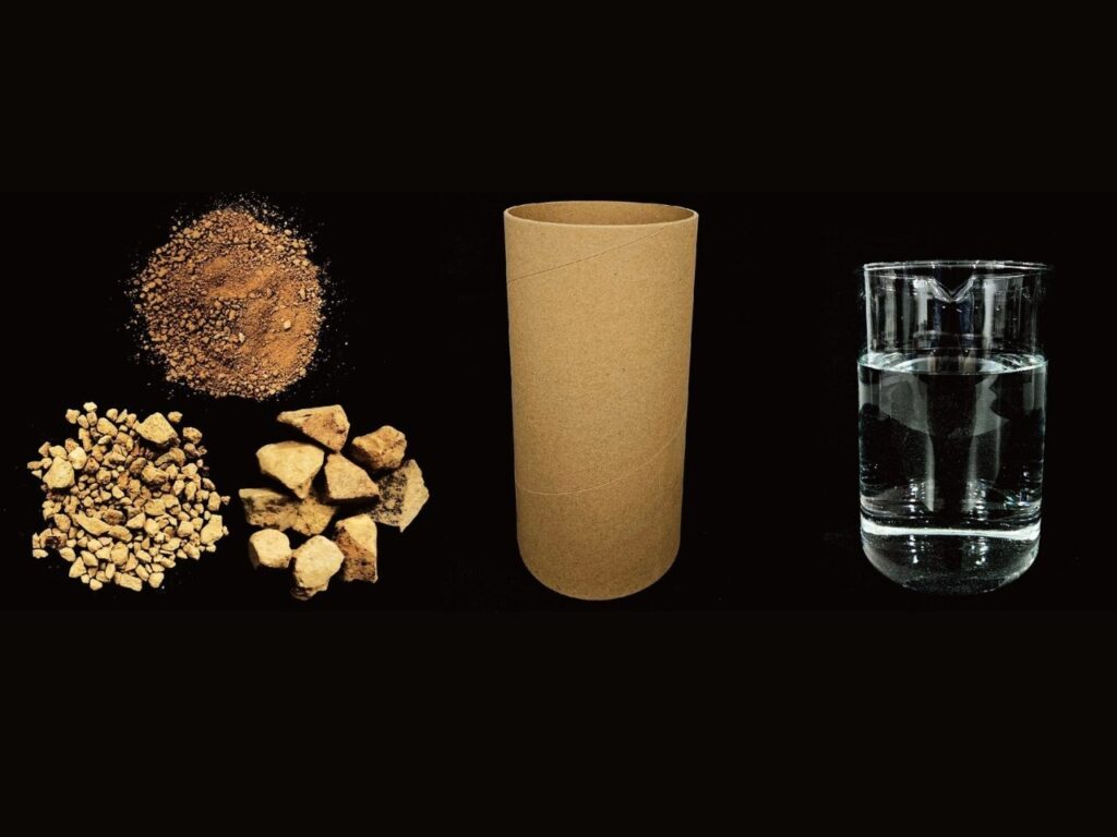 Compressed soil inside cardboard tubes forming sustainable CCRE material