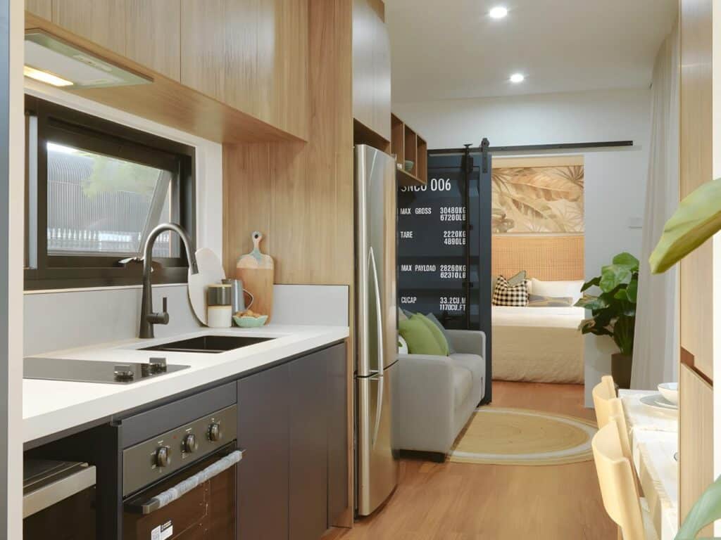 Fully equipped kitchen in Mark VI &ndash; VIC home with fridge, oven, induction stove, and storage space