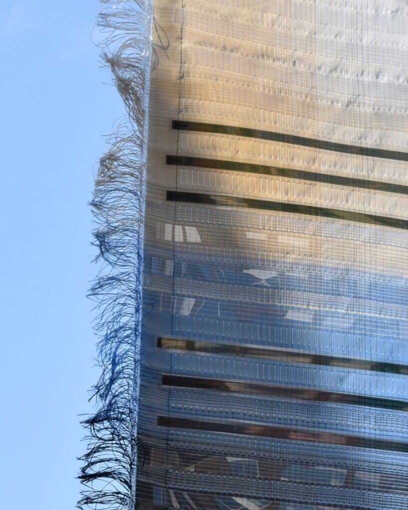 Umbra Pavilion facade with sky-blue roof and Heliotex solar materials