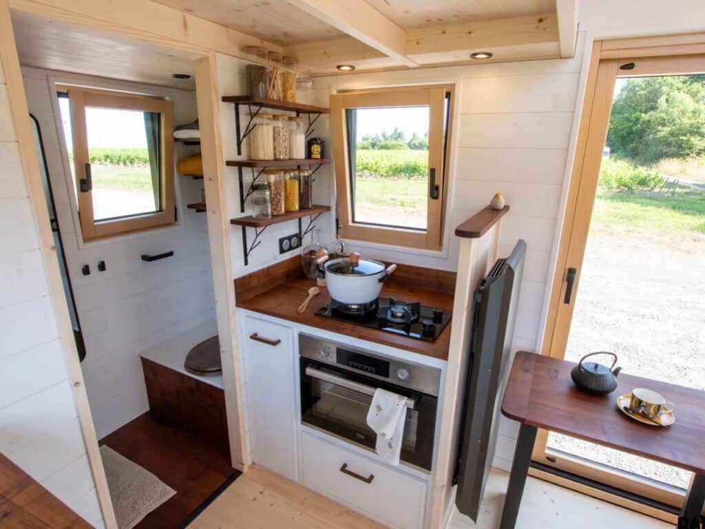 Exterior design of a small house featuring natural wood and black accents