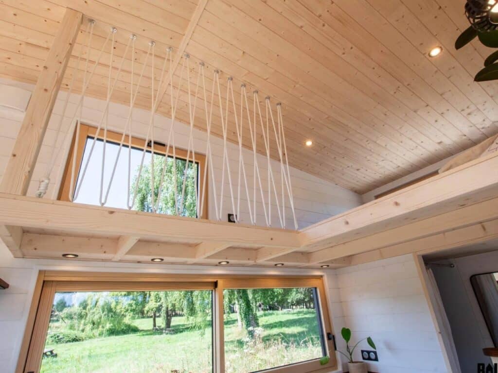 Exterior design of a small house featuring natural wood and black accents