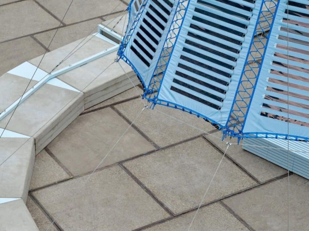 Umbra Pavilion facade with sky-blue roof and Heliotex solar materials