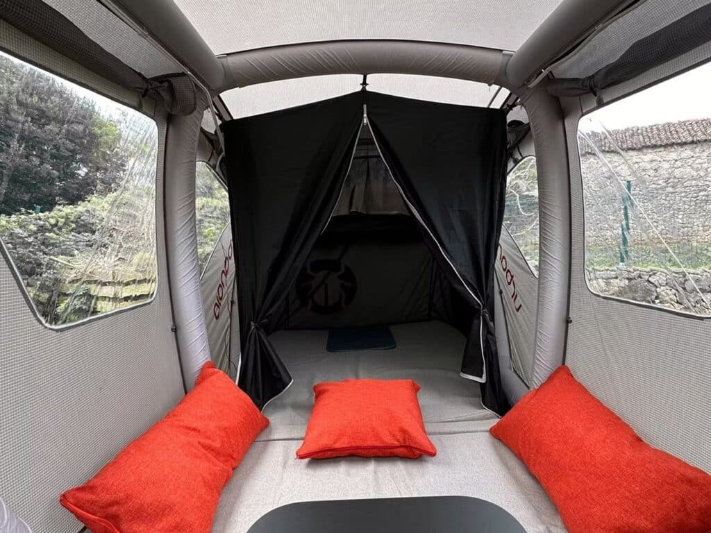 Booba trailer converted into a fully equipped tent with seating area