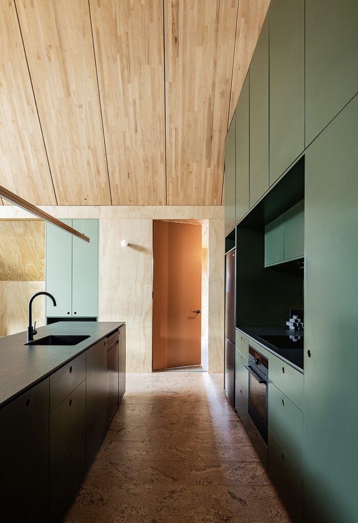 Exterior view of Adventure Whare resort surrounded by trees and forests, featuring traditional A-frame design with modern touches.