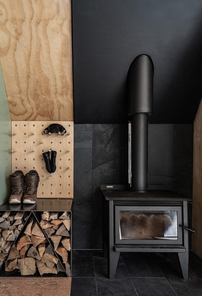 Exterior view of Adventure Whare resort surrounded by trees and forests, featuring traditional A-frame design with modern touches.