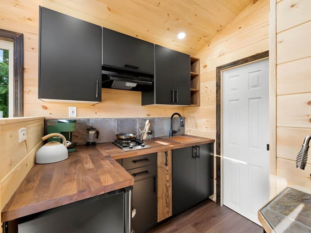 Exterior view of Little Lodge tiny home with wood and metal facade