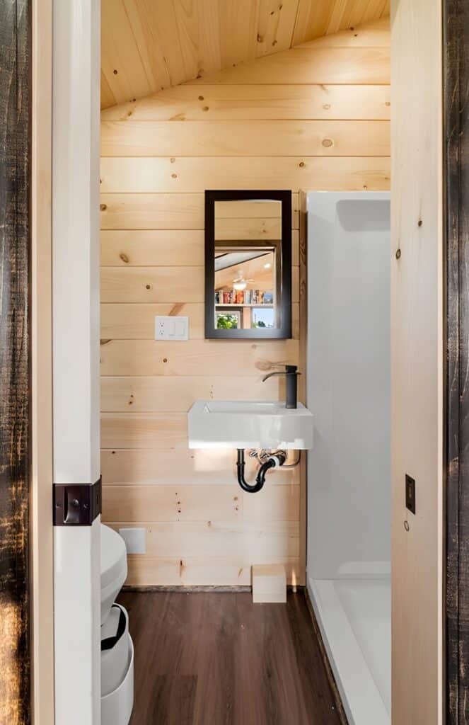 Exterior view of Little Lodge tiny home with wood and metal facade