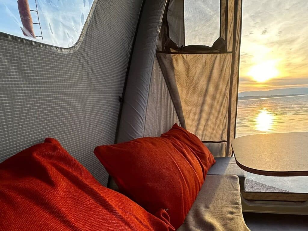 Booba trailer converted into a fully equipped tent with seating area