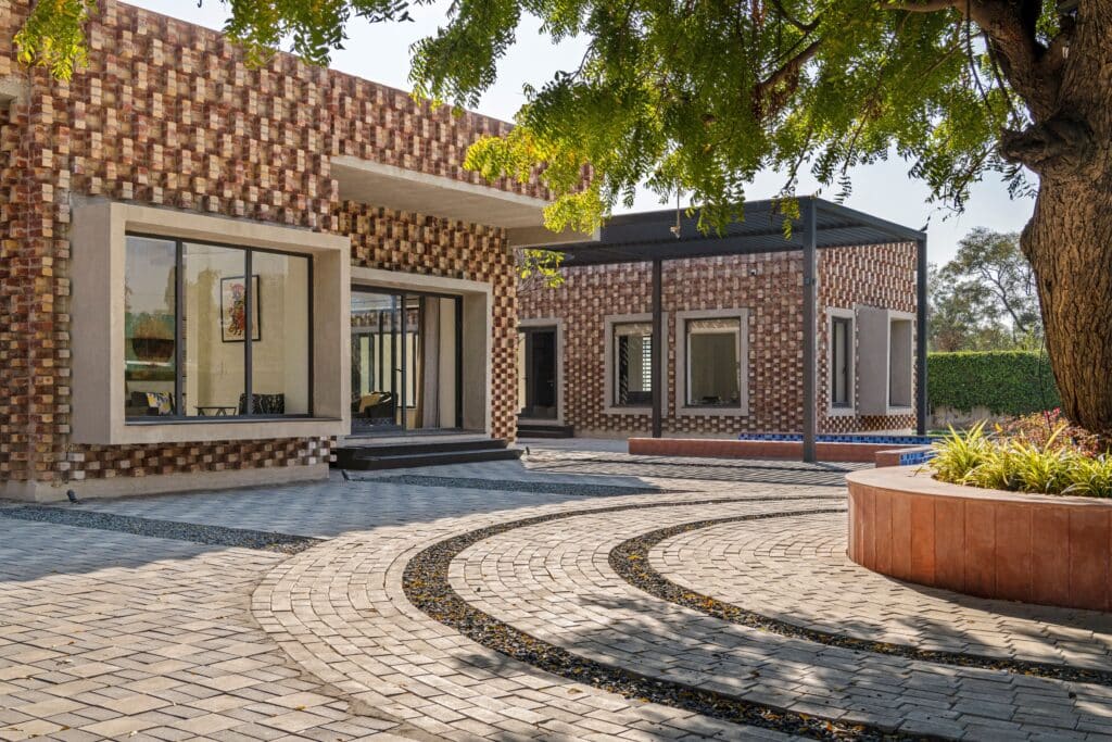 Brick House fa&ccedil;ade in New Delhi showing graduated brick patterns and trellis structure.