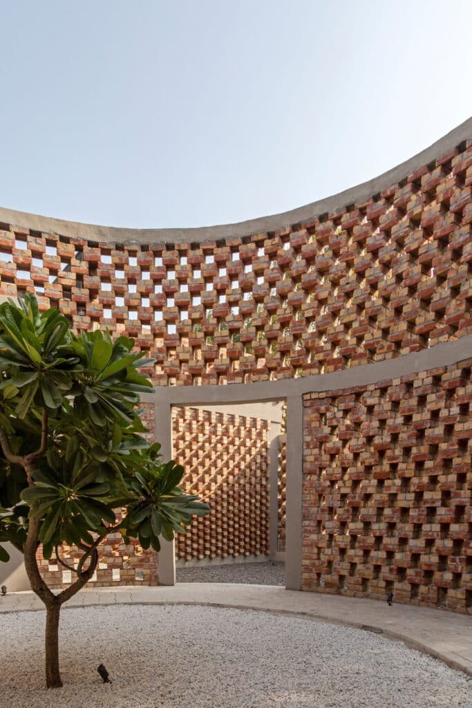 Brick House fa&ccedil;ade in New Delhi showing graduated brick patterns and trellis structure.