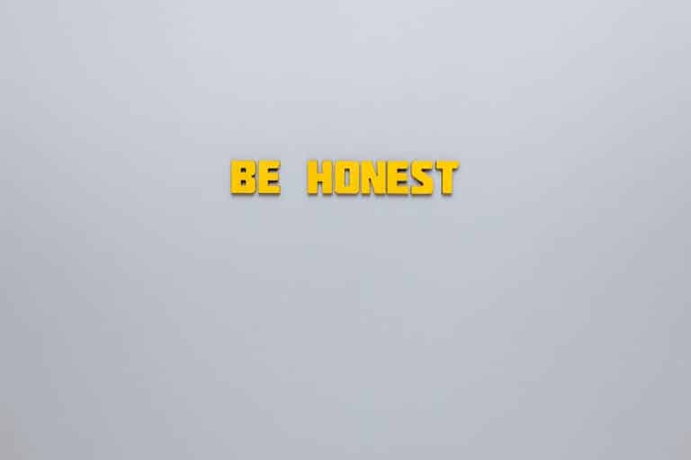 Simple yellow text 'Be Honest' on a neutral background, emphasizing clarity and inspiration.