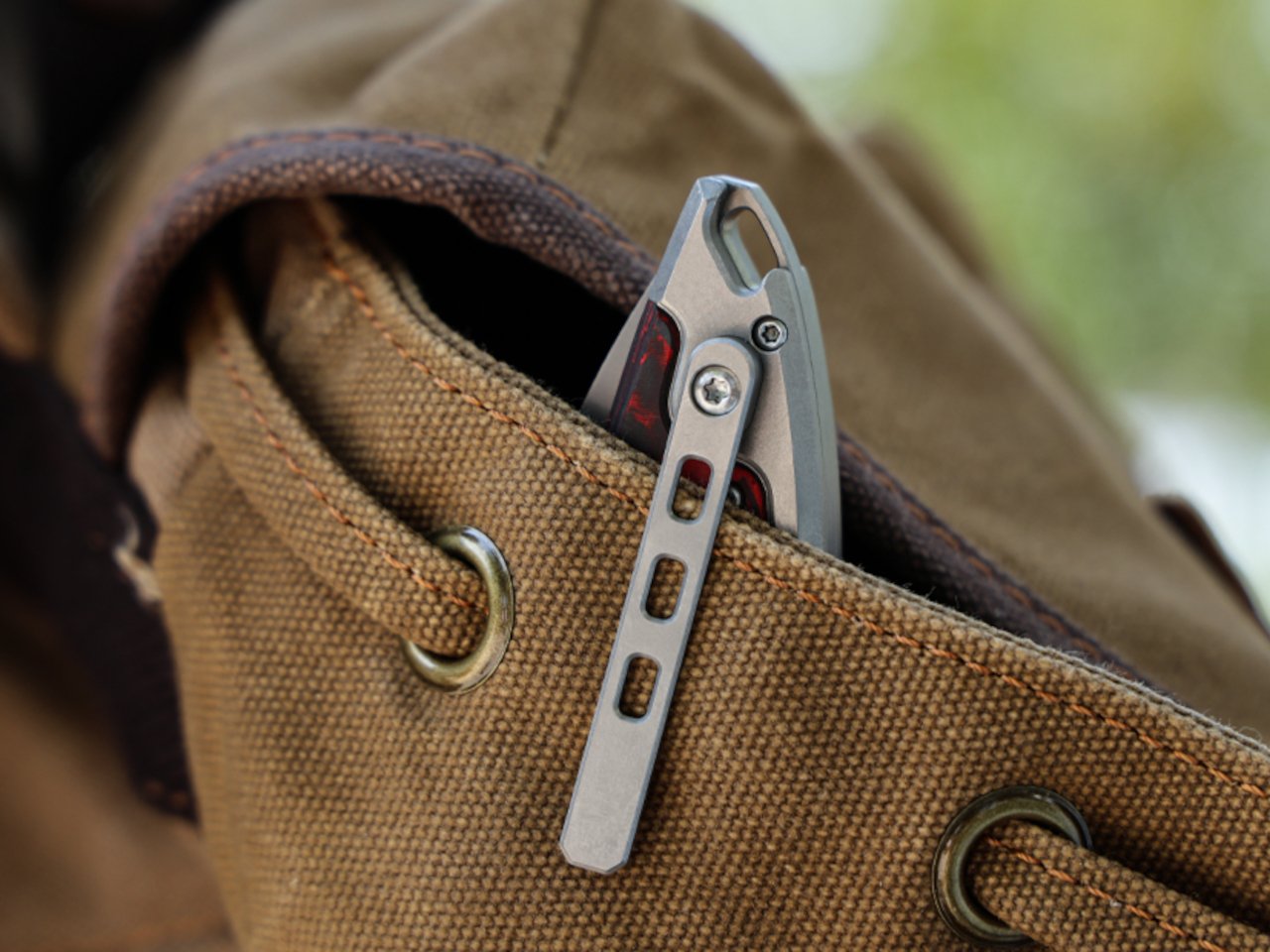 Close-up of the Scarab 2.0 EDC knife showing carbon fiber and titanium materials