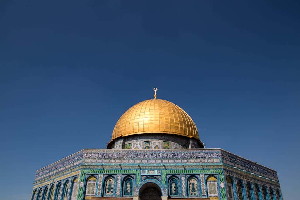 The stunning Dome of the Rock with its golden dome under a clear blue sky in Jerusalem.