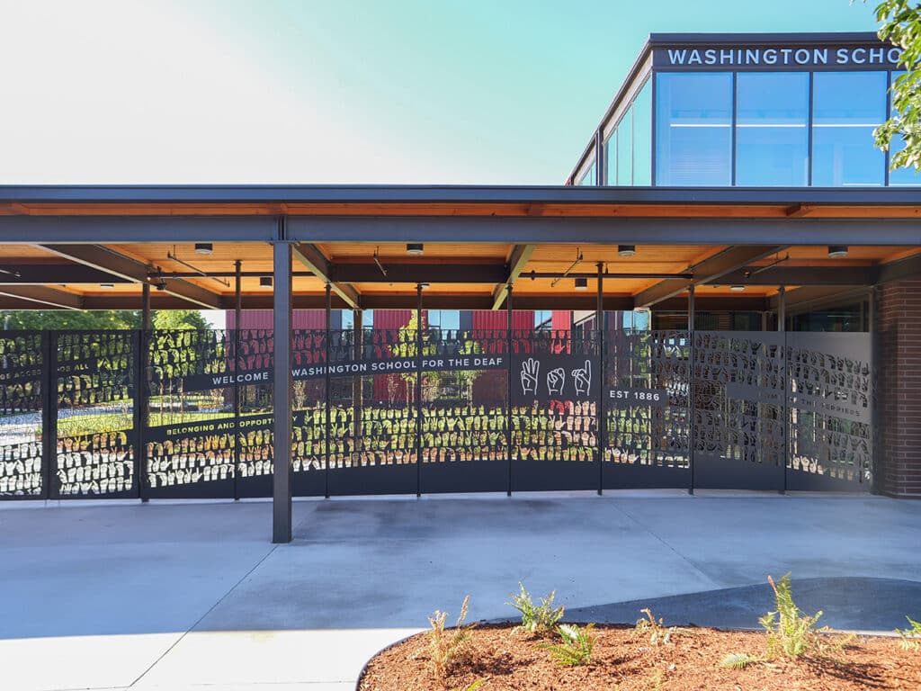 Glass-wood entrance welcoming visitors with soft lighting and smooth spatial flow.