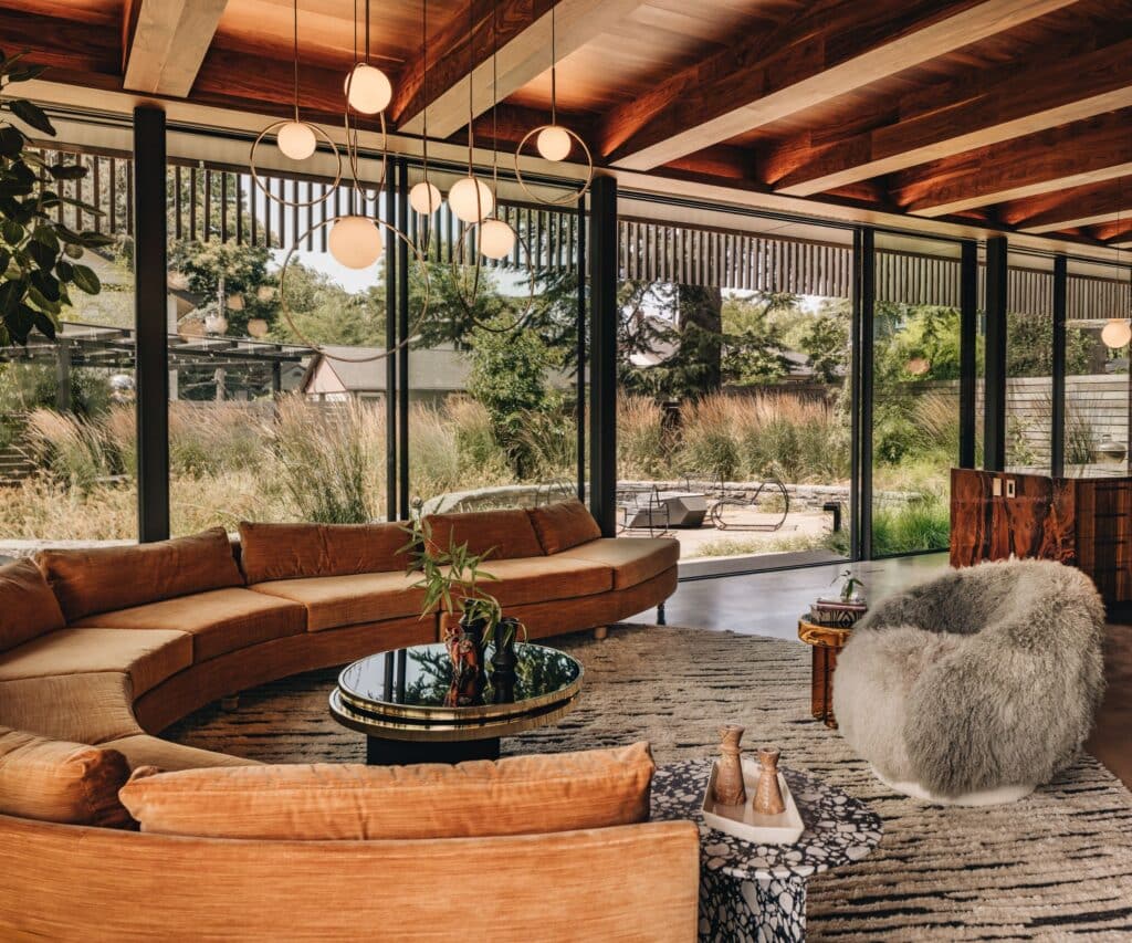 Large glass walls distribute light and open interior spaces